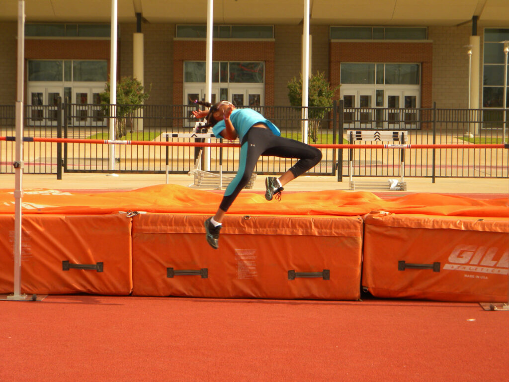 A young athlete executing the Fosbury Flop technique in a high jump