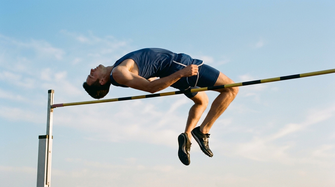 Adult athlete demonstrating the arched position over the bar during the high jump flight phase